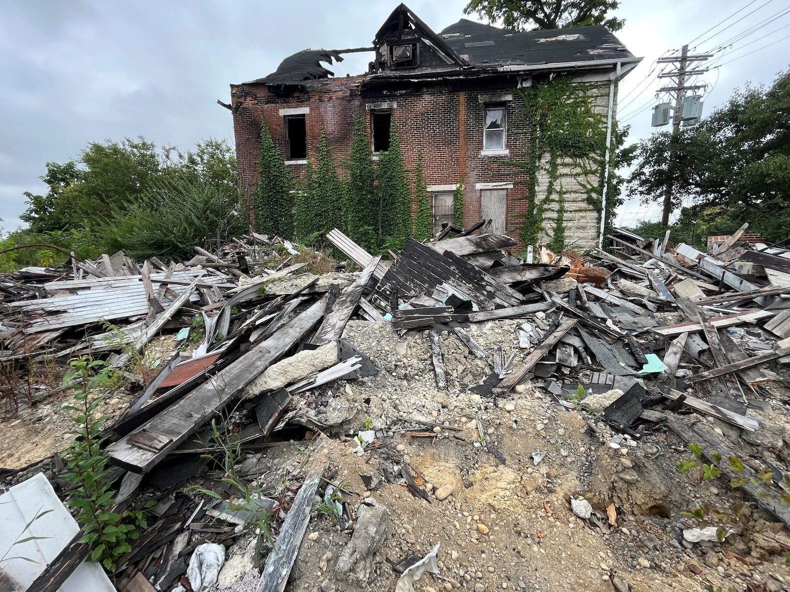 A pile of burnt debris and rubble at 508 N. Broadway St. in West Dayton. Five people were found dead inside the property after it burned down earlier this year. CORNELIUS FROLIK / STAFF