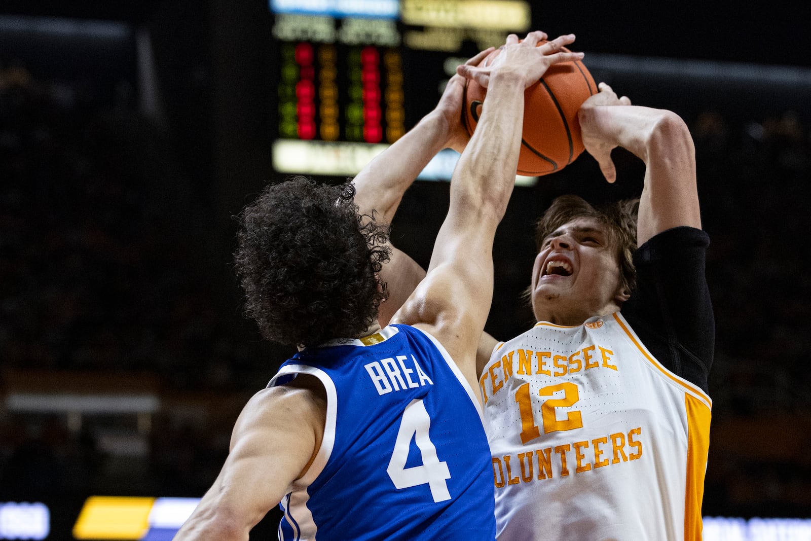 Tennessee forward Cade Phillips (12) shoots as he's fouled by Kentucky guard Koby Brea (4) during the first half of an NCAA college basketball game, Tuesday, Jan. 28, 2025, in Knoxville, Tenn. (AP Photo/Wade Payne)