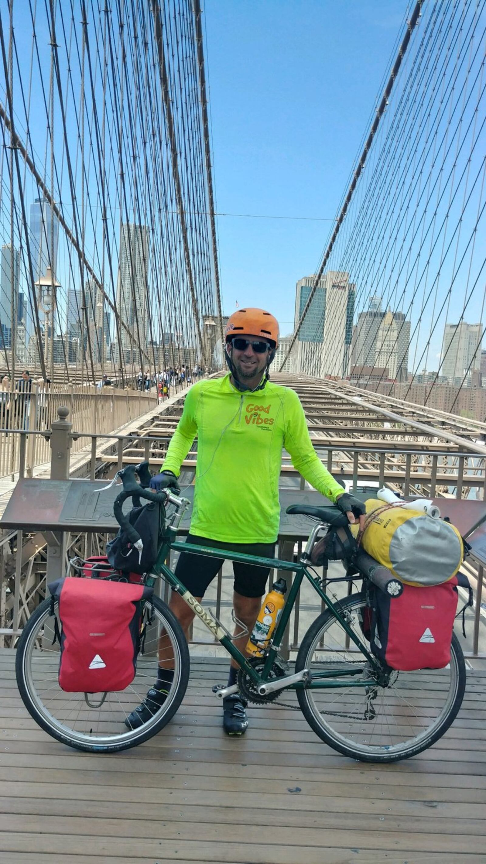 Tom Helbig poses on the Brooklyn Bridge during his recent 3,000-mile Tomfoolery Outdoors Good Vibes Tour. CONTRIBUTED