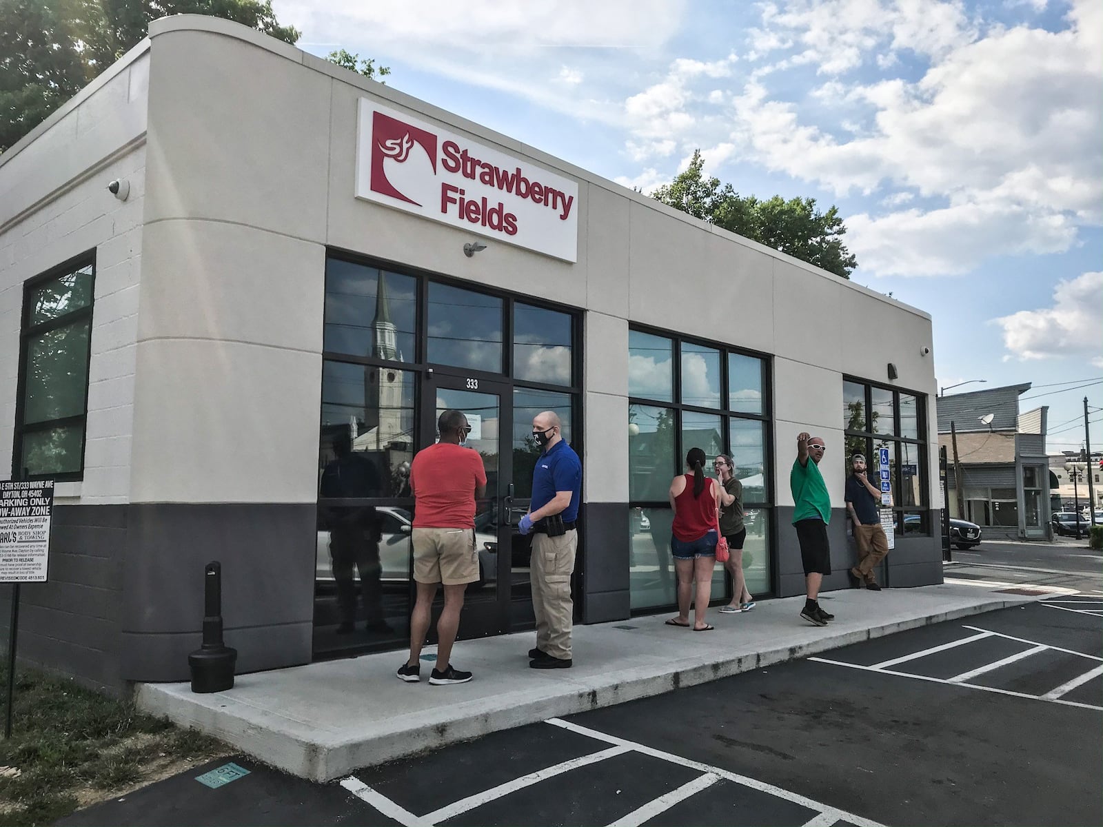 People line-up outside of Strawberry Fields on Wayne Ave. Strawberry Fields is a medical marijuana dispensary in Ohio with three other locations around the state. JIM NOELKER/STAFF