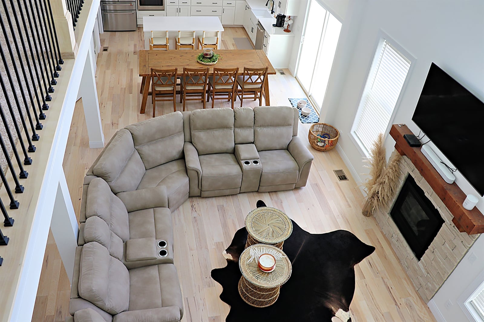 Engineered, white-pine wood plank flooring fills the foyer and flows throughout the main level social areas. Straight off the foyer hallway, a great room has a two-story ceiling with a ceiling fan. Five windows surround a stone, gas fireplace with a barn-beam mantel. CONTRIBUTED PHOTO BY KATHY TYLER