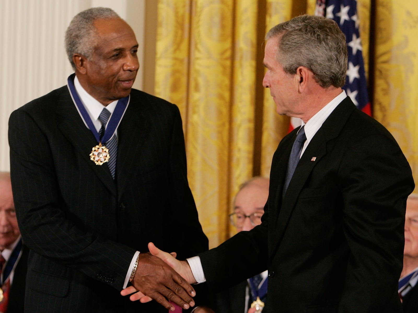 WASHINGTON - NOVEMBER 09:  U.S. President George W. Bush (R) congratulates baseball Hall of Famer Frank Robinson after presenting him with the medal of Freedom during a ceremony at the White House November 9, 2005 in Washington DC. President Bush presented medals to the 2005 Medal of Freedom recipients during a ceremony in the East Room.  (Photo by Mark Wilson/Getty Images)