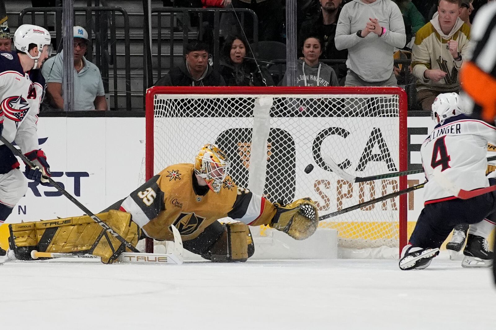 Columbus Blue Jackets center Cole Sillinger (4) scores on Vegas Golden Knights goaltender Ilya Samsonov (35) during overtime of an NHL hockey game Thursday, Jan. 30, 2025, in Las Vegas. (AP Photo/John Locher)