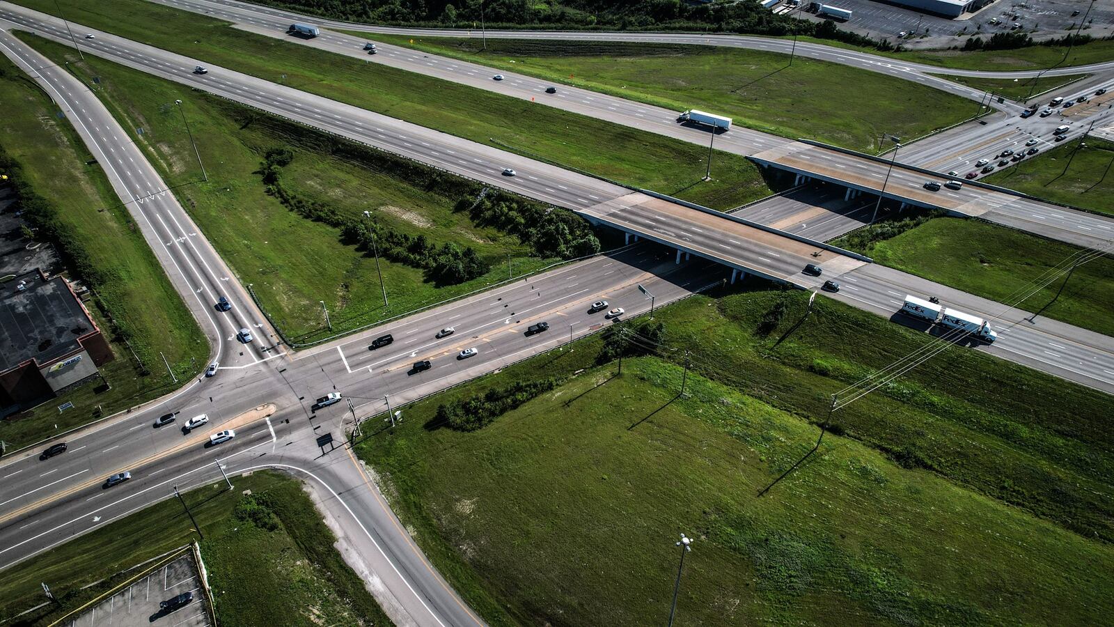 An aerial photo shows the busy intersection of Interstate 75 and Ohio 725 near the Dayton Mall. The Ohio Department of Transportation is delaying plans for a Diverging Diamond interchange at the intersection until three years of traffic study data can be amassed for a project that altered the timing of traffic signals in the area, improving safety and vehicle flow. JIM NOELKER/STAFF