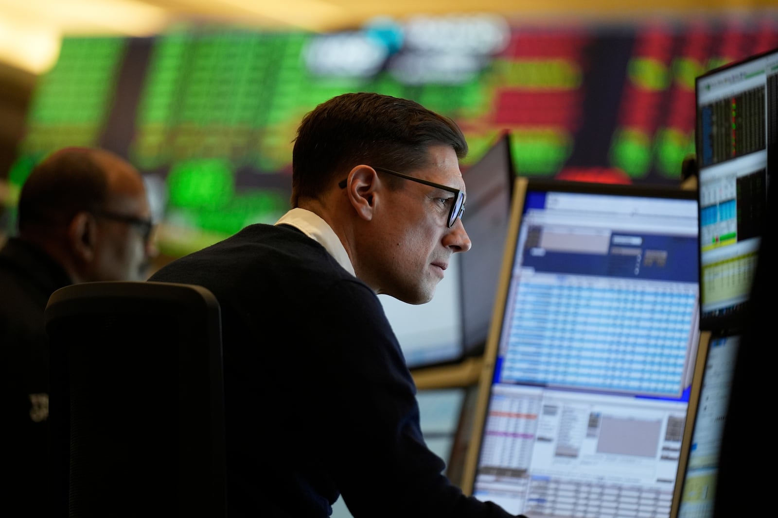 People work on the options floor at the New York Stock Exchange in New York, Wednesday, March 19, 2025. (AP Photo/Seth Wenig)