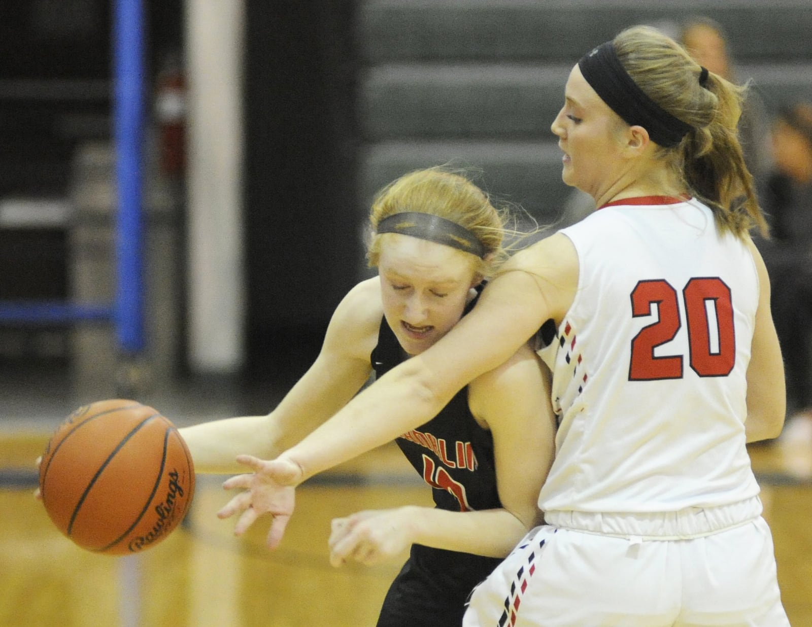 Franklin’s Jordan Rogers tries to fight her way past Tippecanoe’s Ashleigh Mader (20) during Friday night’s Division II district championship basketball game at Mason Arena. Franklin won 49-39. MARC PENDLETON/STAFF