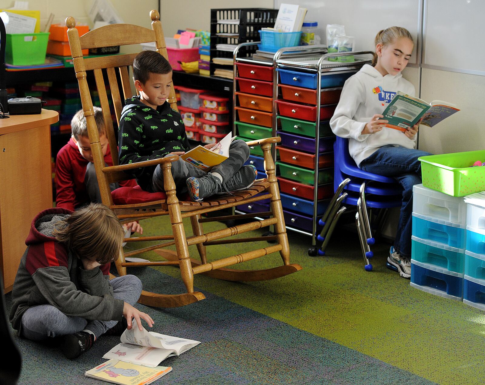 Charles Huber Elementary students from left, Zane Railey, Landon Pierce, Zander Rice and Savannah Guillozet reads books in class Thursday Nov. 3, 2022. MARSHALL GORBY\STAFF