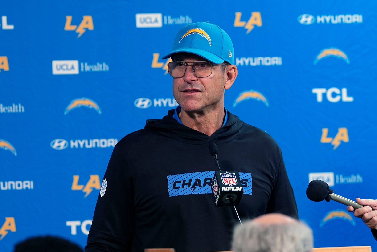 Los Angeles Chargers head coach Jim Harbaugh responds to a question during news conference after defeating the Denver Broncos in an NFL football game Sunday, Oct. 13, 2024, in Denver. (AP Photo/David Zalubowski)