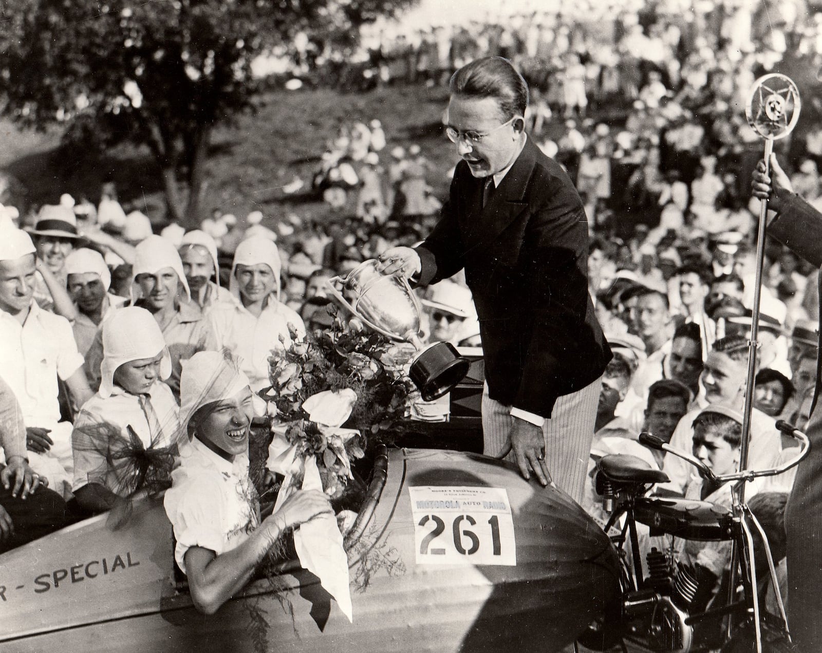 Myron E. Scott awards a prize to Randall Custer of Oakwood one of the winners of the first soap box derby race held in Dayton Aug. 19, 1933. Scott, a Dayton Daily News photographer, came up with the idea for the race after encountering a few boys racing home made cars. DAYTON DAILY NEWS ARCHIVE