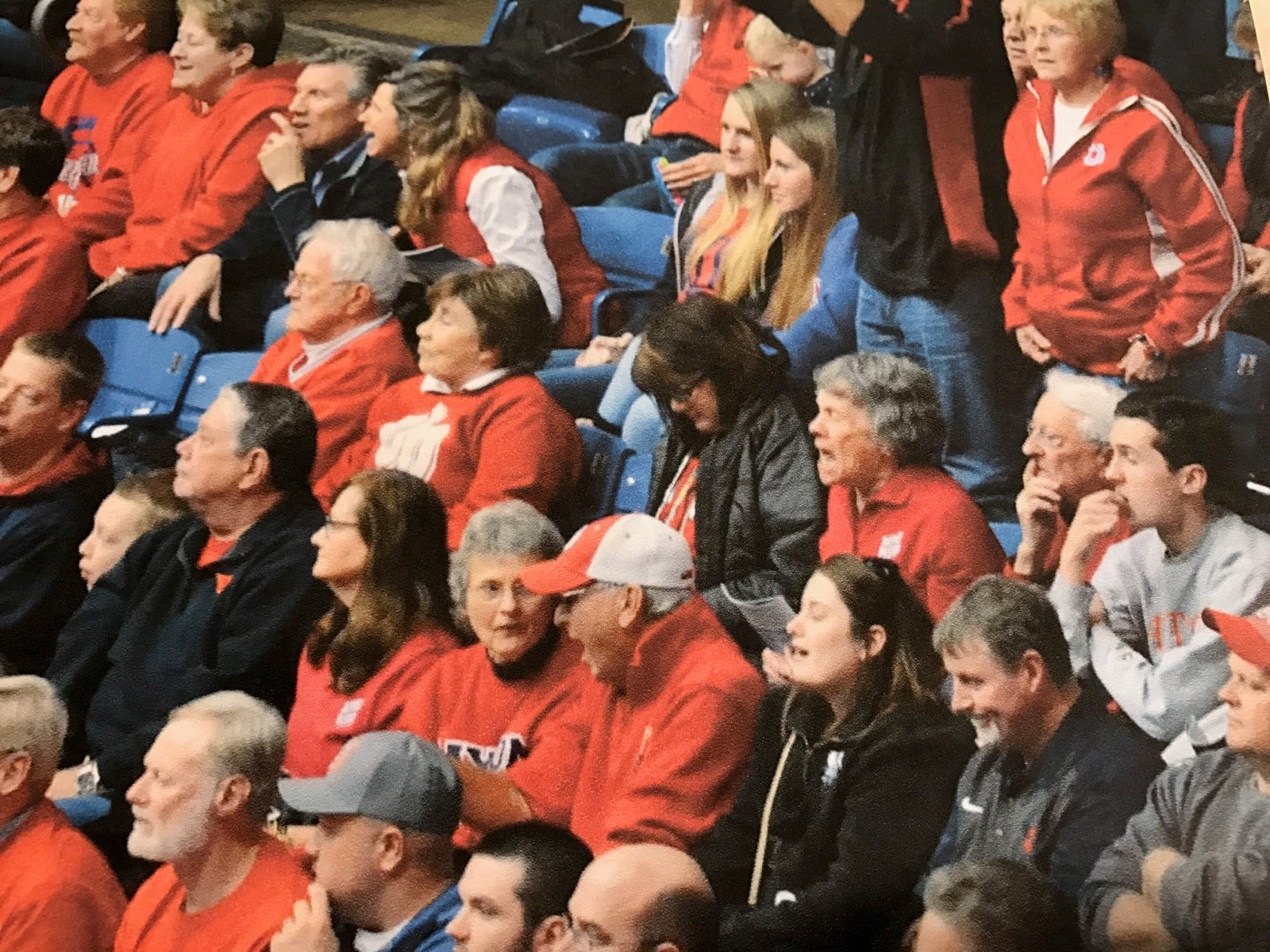 Eileen Stall (in red, third row, third from right) yelling and Paul, her husband of 74 years (to her right, white hair), watching nervously at a Flyers game against Rhode Island in 2015.  (Contributed Photo)