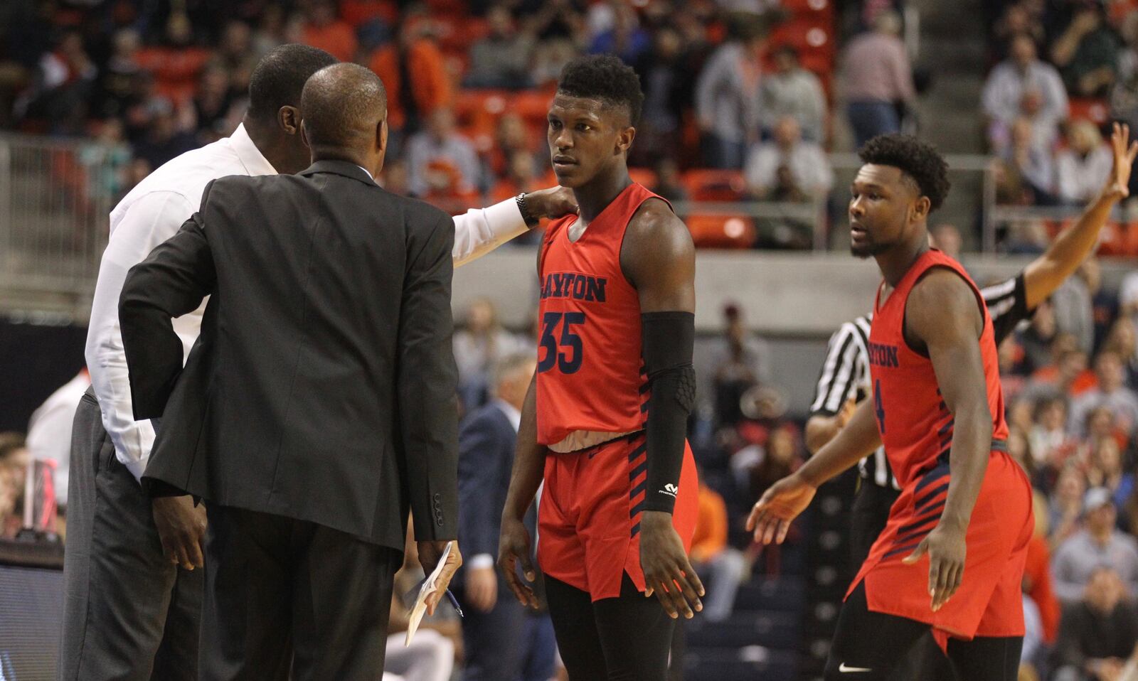 Dayton’s Anthony Grant consoles Dwayne Cohill after a turnover against Auburn on Saturday, Dec. 8, 2018, at Auburn Arena in Auburn, Ala. David Jablonski/Staff