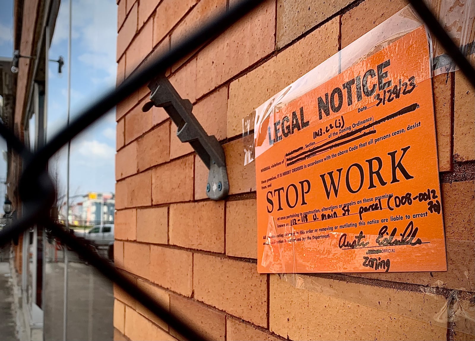 A stop work sign taped to the outside of the 118 Main St. in Troy dated for today, Wednesday, March 29, 2023. MARSHALL GORBY\STAFF