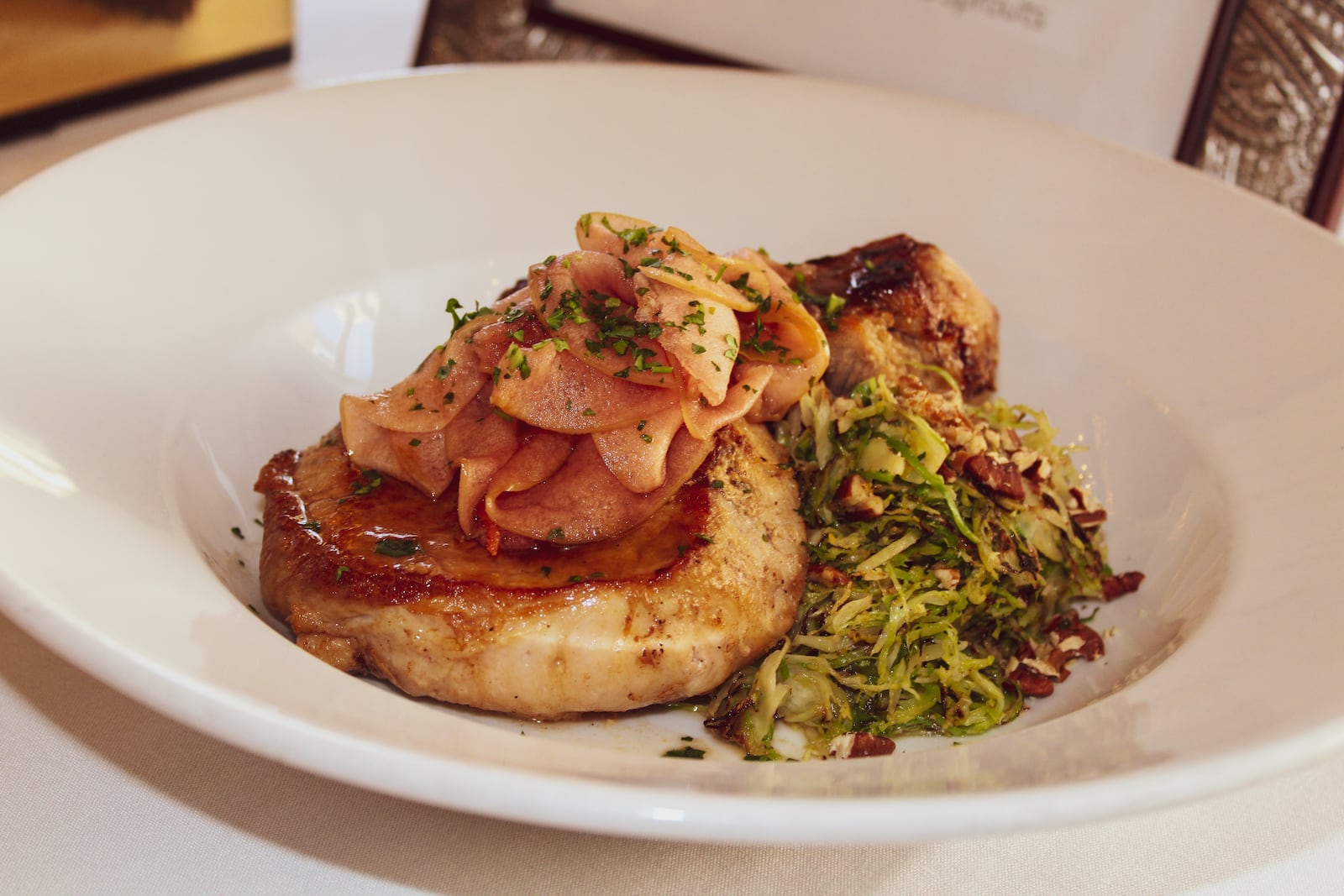 Aaron Braun, a chef at Meadowlark Restaurant won the top honors at the Ohio Pork Council’s  2019 Taste of Elegance Chef Competition and Legislative Reception in New Albany. His cider-glazed pork loin with spicy pickled apple, butternut squash gratin and shredded Brussels sprouts is pictured.