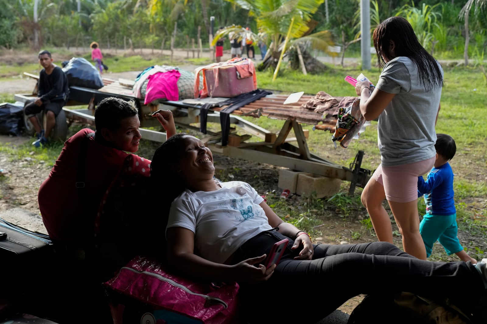 Karla Castillo rests with other Venezuelan migrants in Puerto Carti, on Panama's Caribbean coast, Saturday, Feb. 22, 2025, where they plan to board boats to Colombia after turning back from southern Mexico where they gave up hopes of reaching the U.S. amid President Trump's crackdown on migration. (AP Photo/Matias Delacroix)