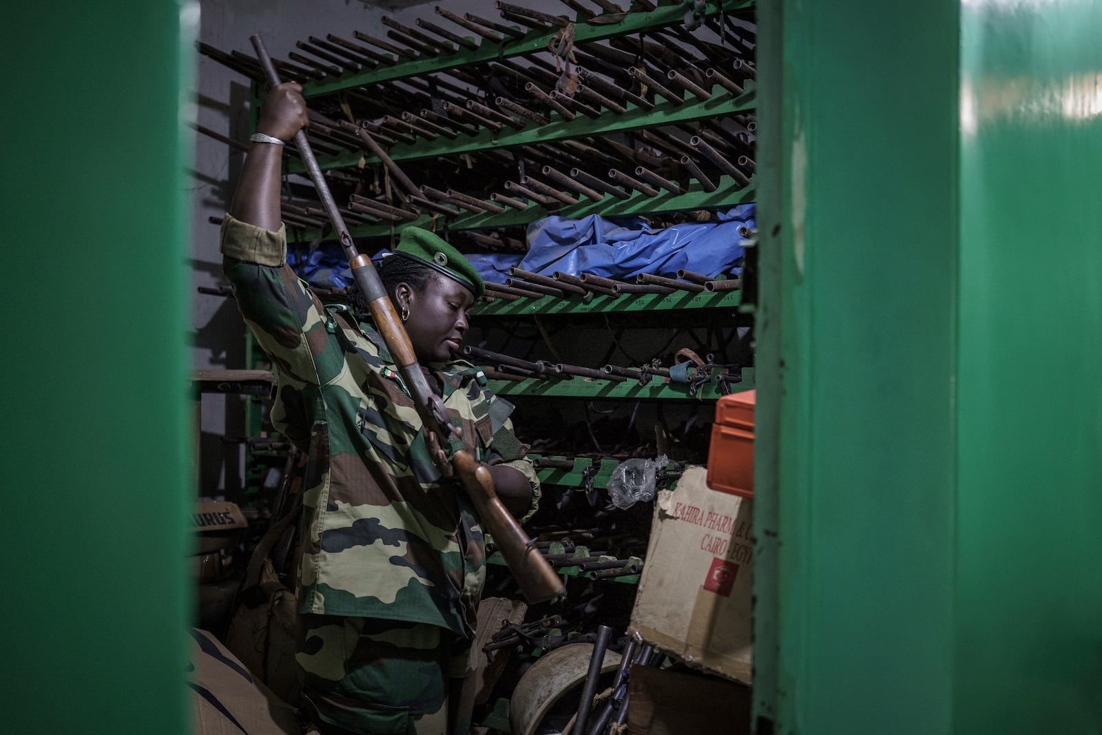 Ndeye Seck, a sublieutenant with Senegal's Direction of National Parks, sifts through confiscated guns at the DPN headquarters in Tambacounda, Senegal on Monday, Jan. 13, 2025. (AP Photo/Annika Hammerschlag)