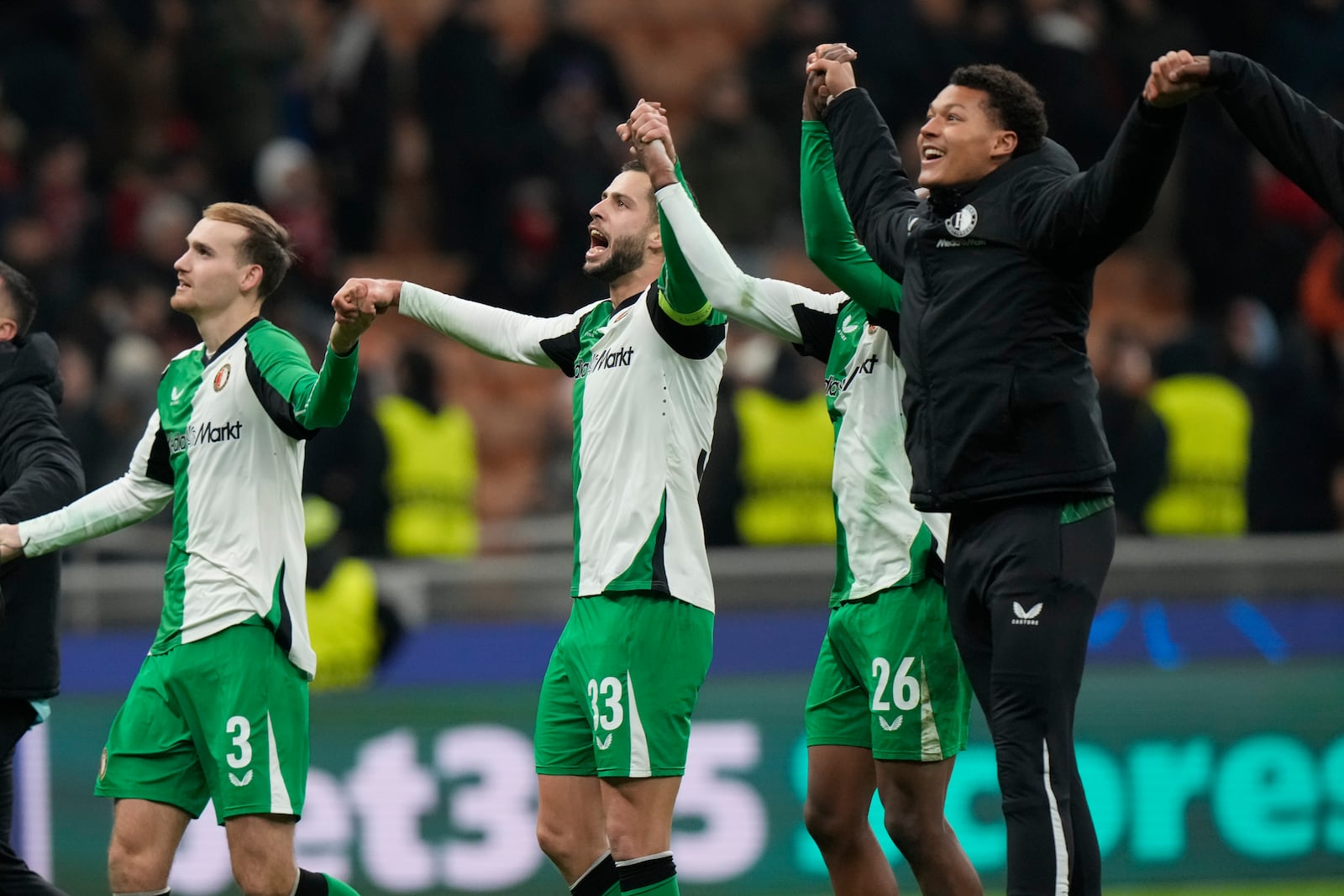 Feyenoord players celebrate after the Champions League, playoff second leg soccer match between AC Milan and Feyenoord, at the San Siro stadium in Milan, Italy, Tuesday, Feb.18, 2025. (AP Photo/Luca Bruno)