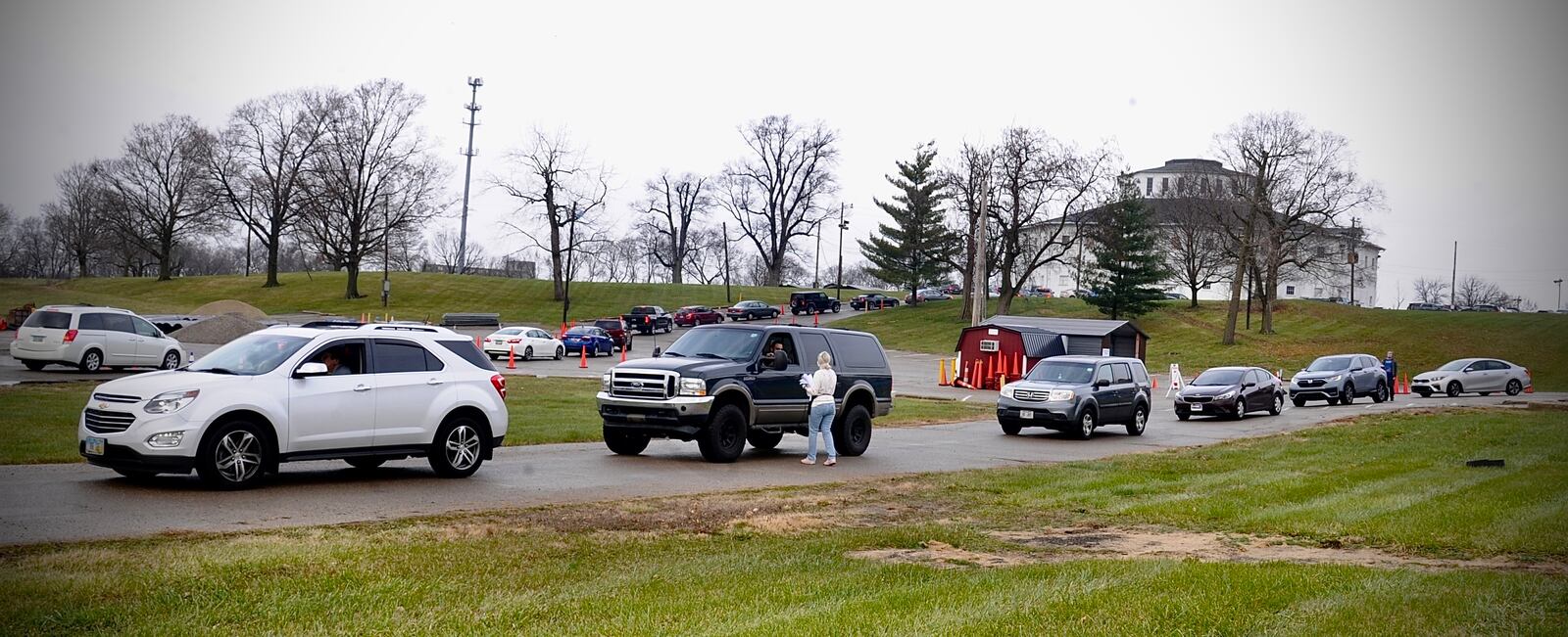 Cars waiting in line for COVID testing at the old Montgomery County fairgrounds stretched down N. Main Street to the ER entrance of Miami Valley Hospital Monday morning.