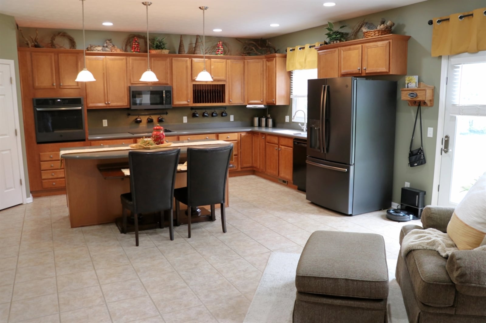 The kitchen offers Corian counters and light cherry cabinetry that fills three walls and offers a planning area and coffee station. 