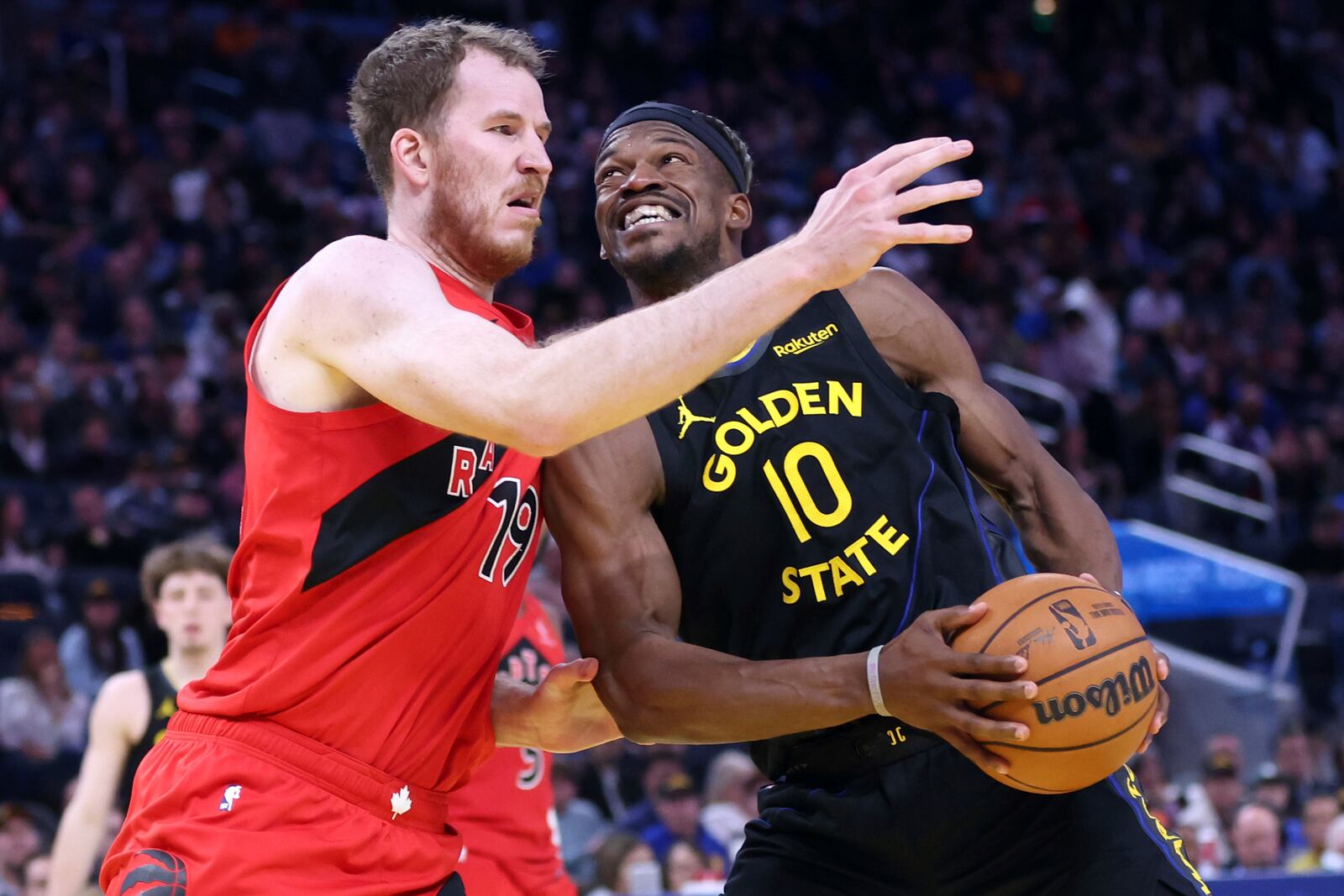 Golden State Warriors' Jimmy Butler III drives against Toronto Raptors' Jakob Poeltl in 4th quarter during Dubs' 117-114 win in NBA game at Chase Center in San Francisco on Thursday, March 20, 2025.(Scott Strazzante/San Francisco Chronicle via AP)