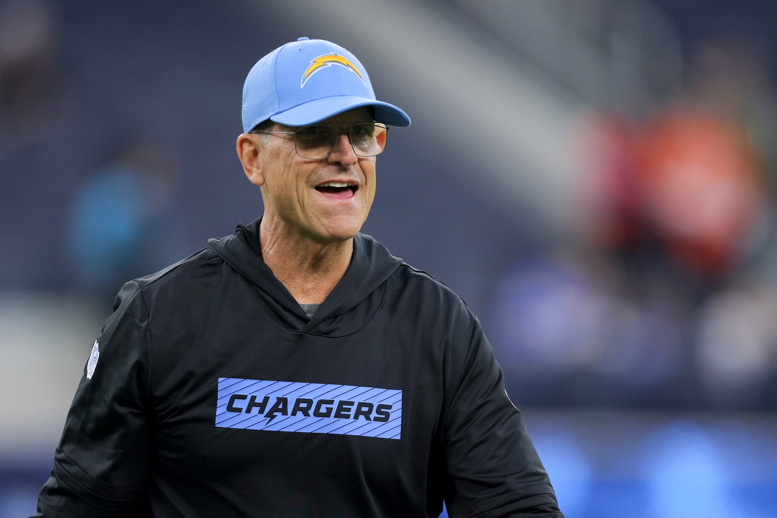 Los Angeles Chargers head coach Jim Harbaugh walks on the field before an NFL football game against the Denver Broncos, Thursday, Dec. 19, 2024, in Inglewood, Calif. (AP Photo/Ryan Sun)