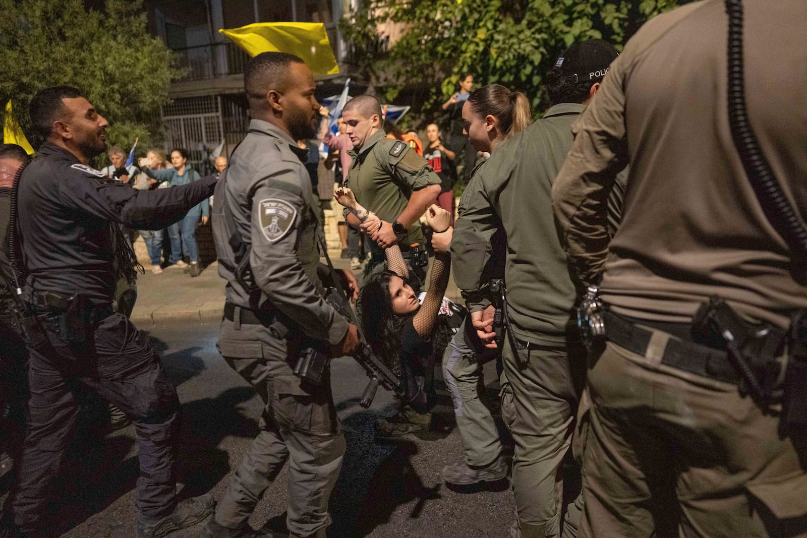 Police disperse people protesting against Prime Minister Benjamin Netanyahu's government and calling for the release of hostages held in the Gaza Strip by the Hamas militant group, near the Prime Minister's residence in Jerusalem, Monday, Oct. 28, 2024. (AP Photo/Ohad Zwigenberg)