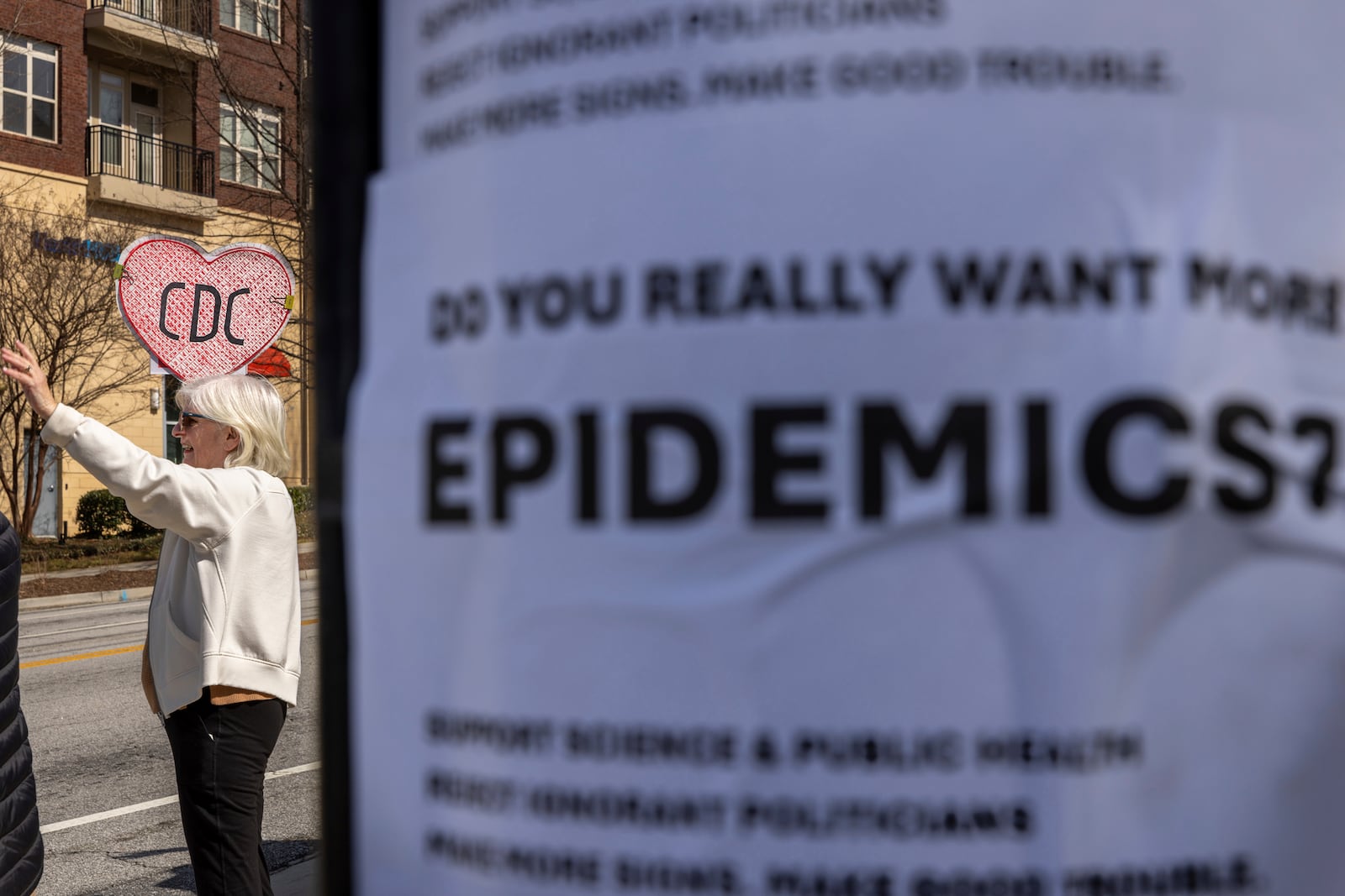 Demonstrators protest the mass firing of 1,000 Centers for Disease Control and Prevention (CDC) employees in front of the CDC headquarters in Atlanta on Tuesday, Feb. 18, 2025. (Arvin Temkar/Atlanta Journal-Constitution via AP)