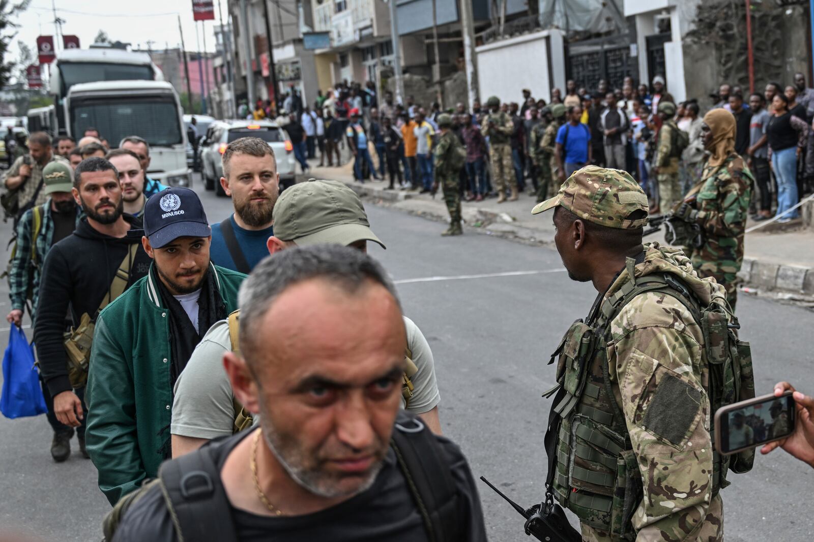 M23 rebels escort Romanian mercenaries to the border crossing into Rwanda in Goma, Democratic Republic of Congo, Wednesday, Jan. 29, 2025.(AP Photo/Moses Sawasawa)