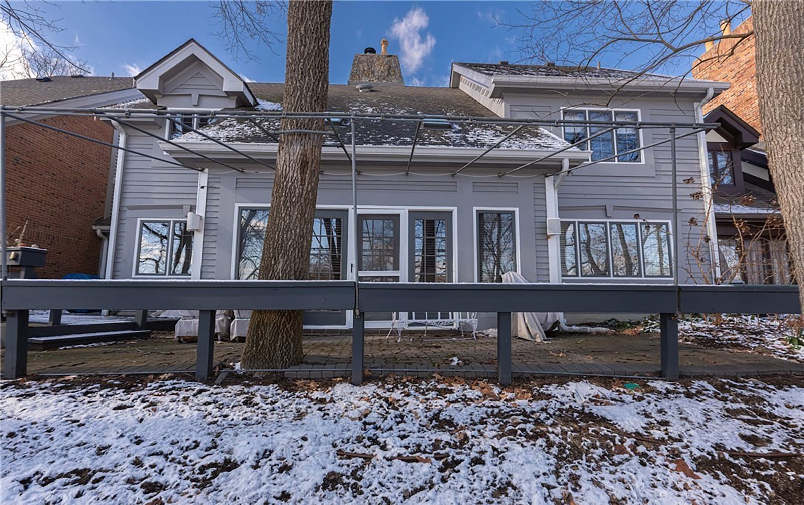 The rear of the home has a covered patio overlooking NCR Golf Course