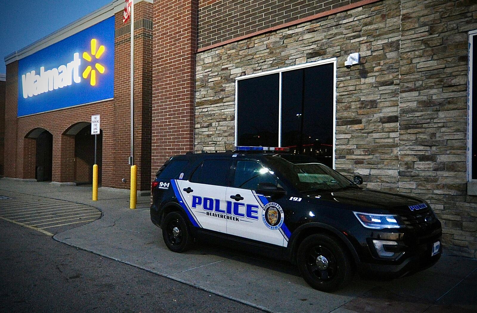 Five police cruisers sit outside the Beavercreek, Walmart on Black Friday, November 24, 2025 the store reopened after a shooting earlier in the week. MARSHALL GORBY \STAFF