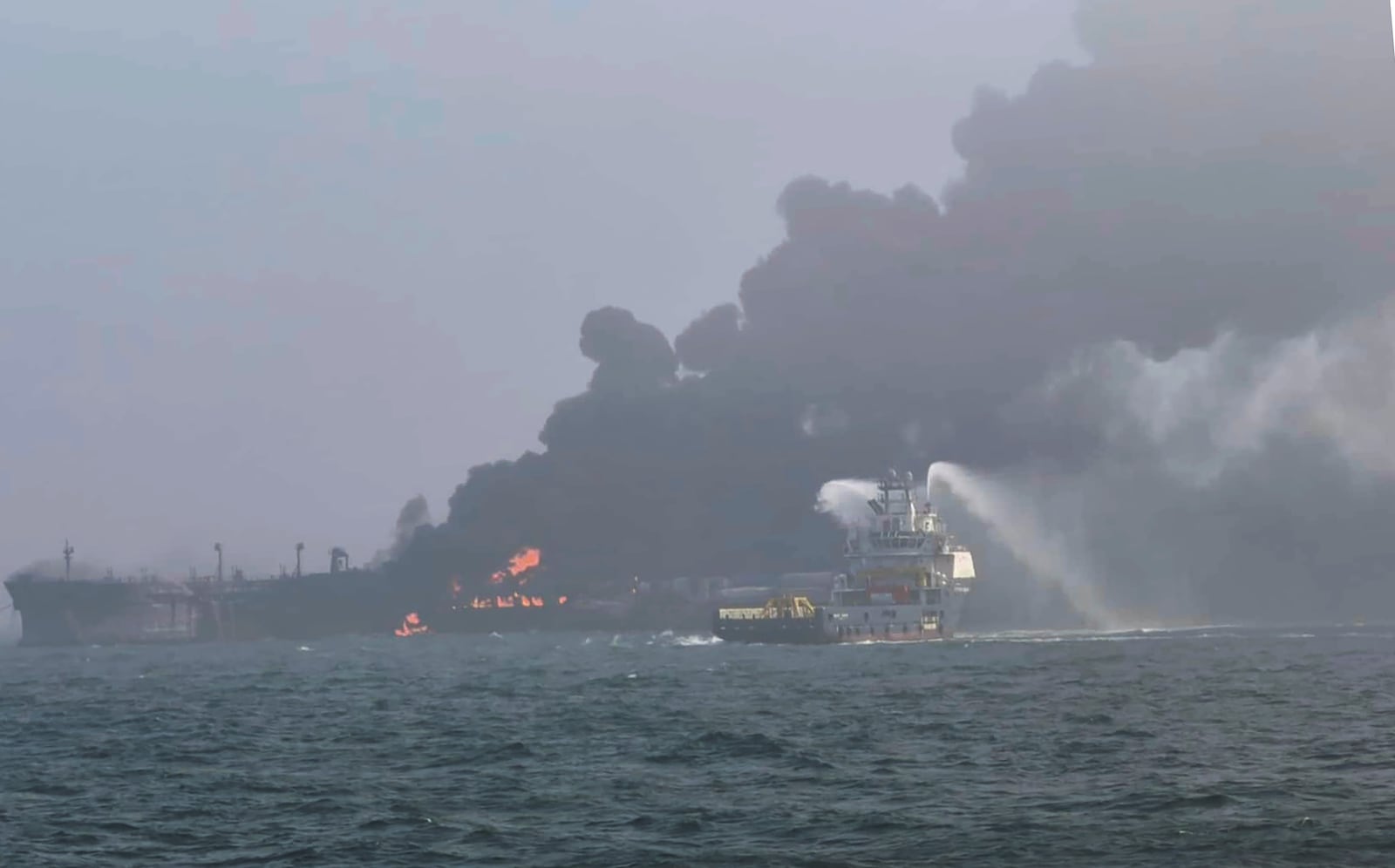 This image provided by Bartek Śmiałek shows smoke billowing from a vessel after a cargo ship hit a tanker carrying jet fuel off eastern England on Monday, March 10, 2025 setting both ablaze and sending fuel pouring into the North Sea. (Bartek Śmiałek via AP)