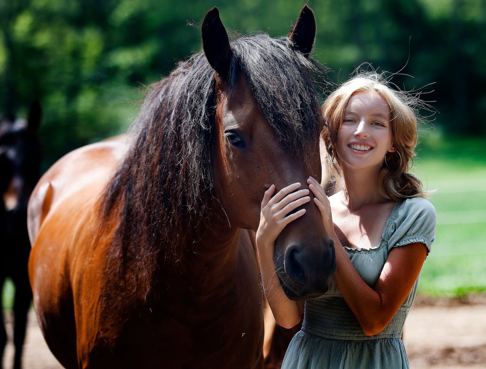 Charlie Pope with her horse Trooper at her home in Greenville. MARSHALL GORBY\STAFF