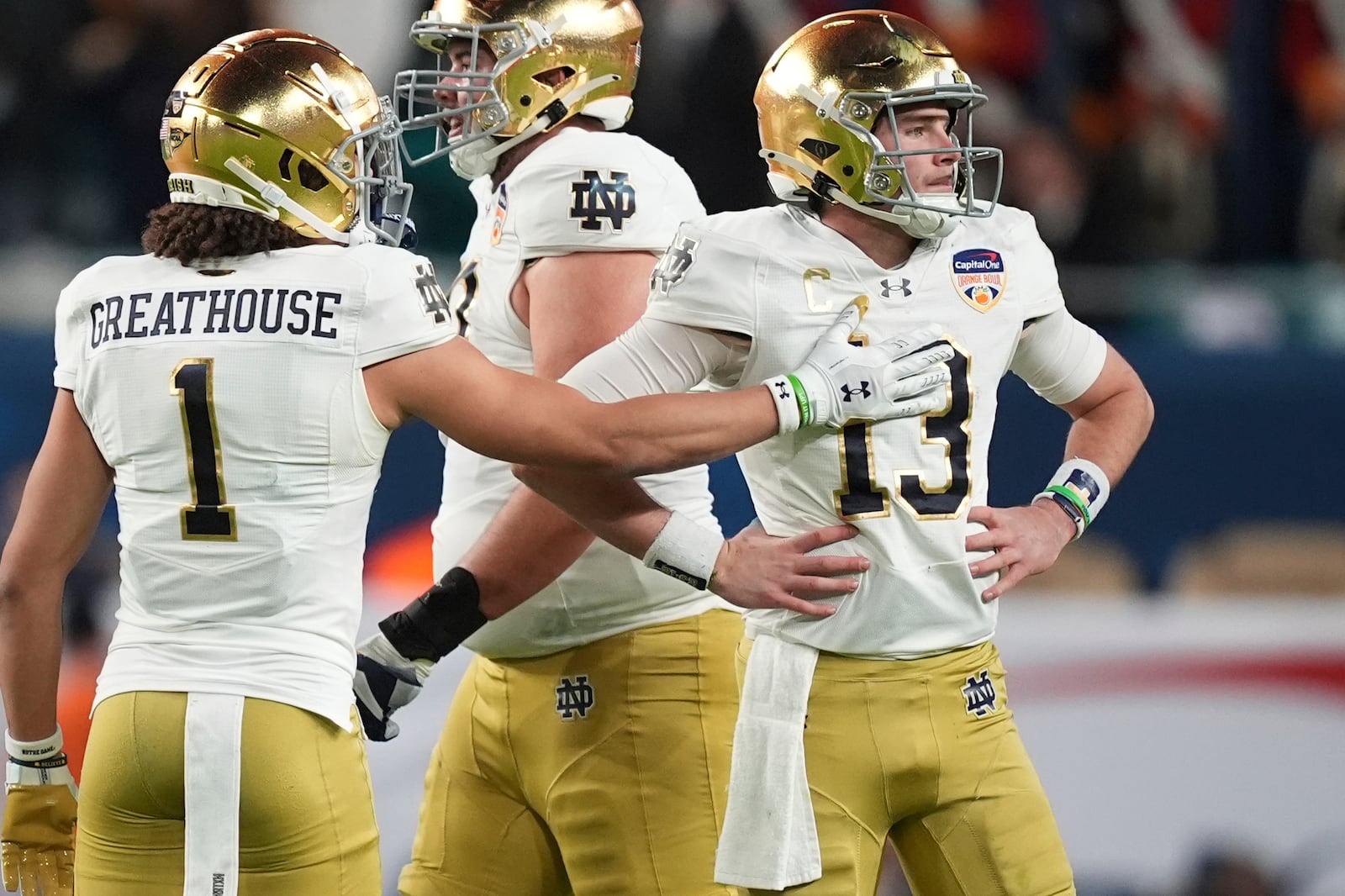 Notre Dame wide receiver Jaden Greathouse (1) reaches out to quarterback Riley Leonard (13) after he was sacked during the first half of the Orange Bowl NCAA College Football Playoff semifinal game against Penn State, Thursday, Jan. 9, 2025, in Miami Gardens, Fla. (AP Photo/Rebecca Blackwell)