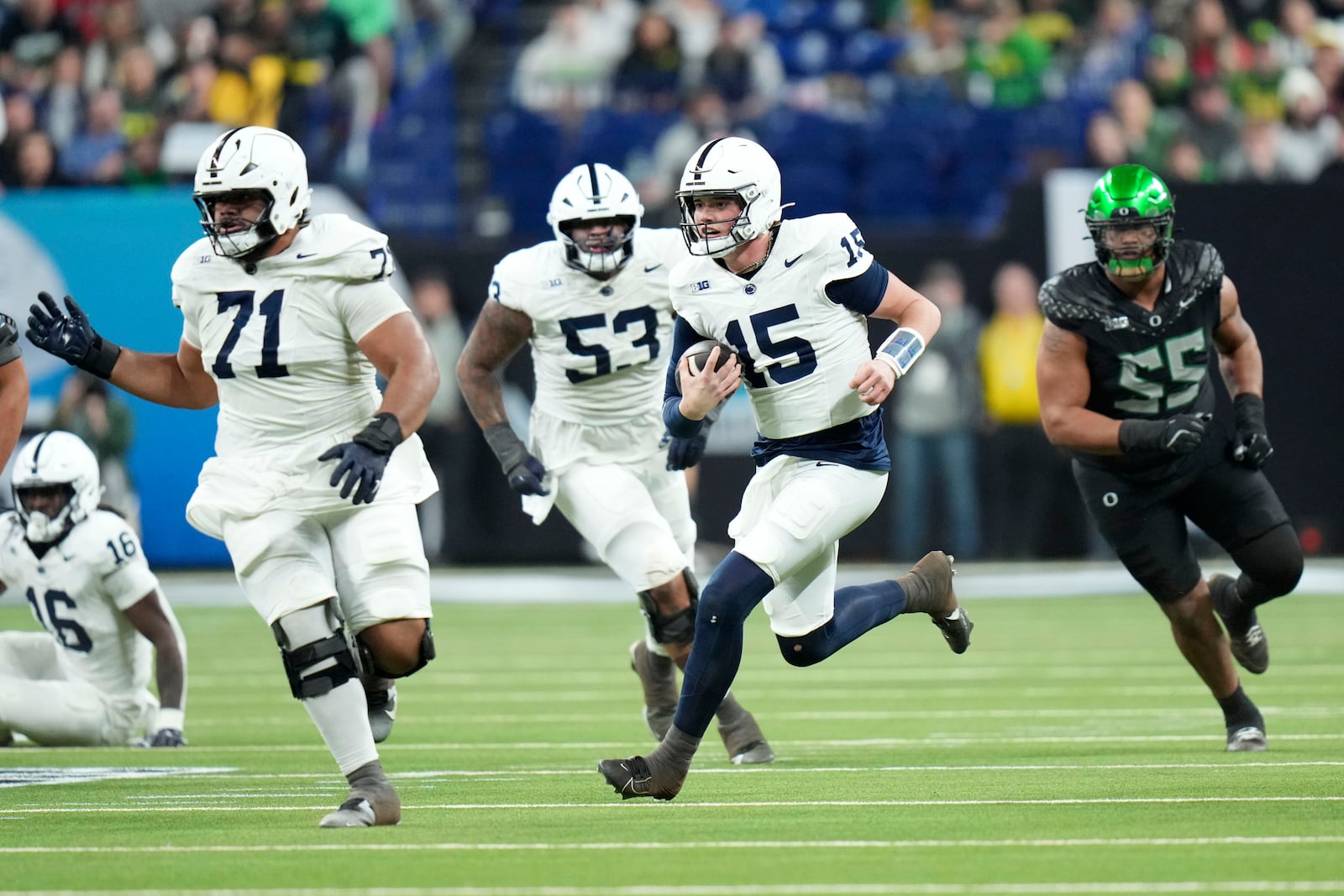 Penn State quarterback Drew Allar (15) runs up field during the first half of the Big Ten championship NCAA college football game against Oregon, Saturday, Dec. 7, 2024, in Indianapolis. (AP Photo/AJ Mast)