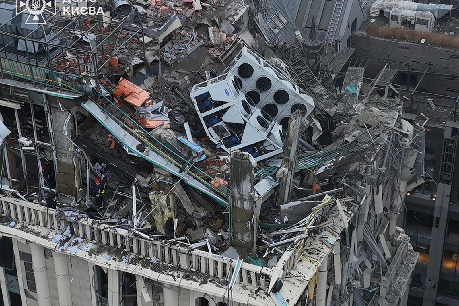 In this photo provided by the Ukrainian Emergency Service, firefighters work on the site of a damaged building after a Russian missile attack in Kyiv, Ukraine, Friday, Dec. 20, 2024. (Ukrainian Emergency Service via AP)