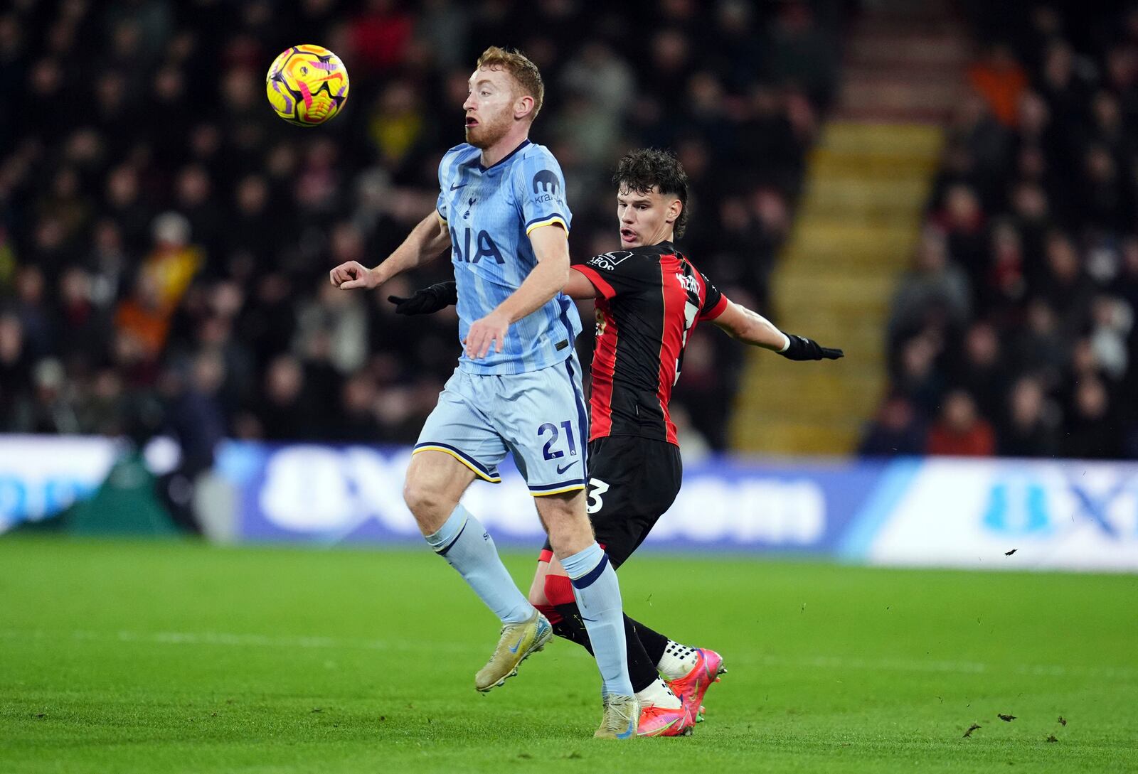 Tottenham Hotspur's Dejan Kulusevski, left, and Bournemouth's Milos Kerkez, right, challenage for the ball during the English Premier League soccer match between AFC Bournemouth and Tottenham Hotspur in Bournemouth, England, Thursday, Dec. 5, 2024. (Adam Davy/PA via AP)