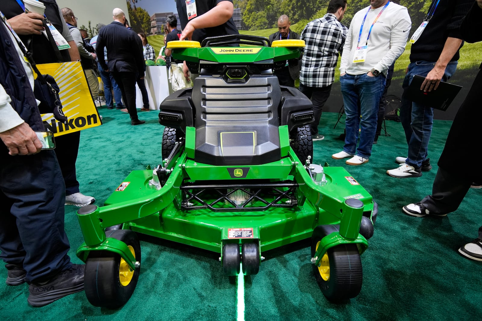 People view an autonomous lawn mower at the John Deere booth during the CES tech show Tuesday, Jan. 7, 2025, in Las Vegas. (AP Photo/John Locher)