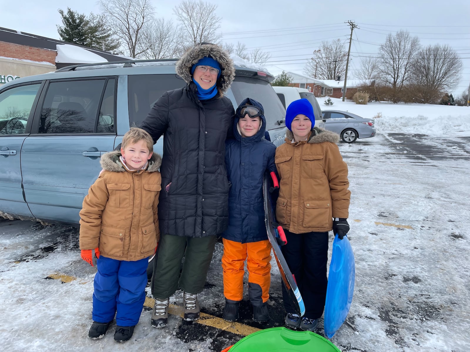 The Palmer Family of Xenia gets ready to walk across the street from St. Brigid Catholic Church in Xenia to sled at Hawkins Hill on Tuesday, Jan. 7. NATALIE JONES/STAFF