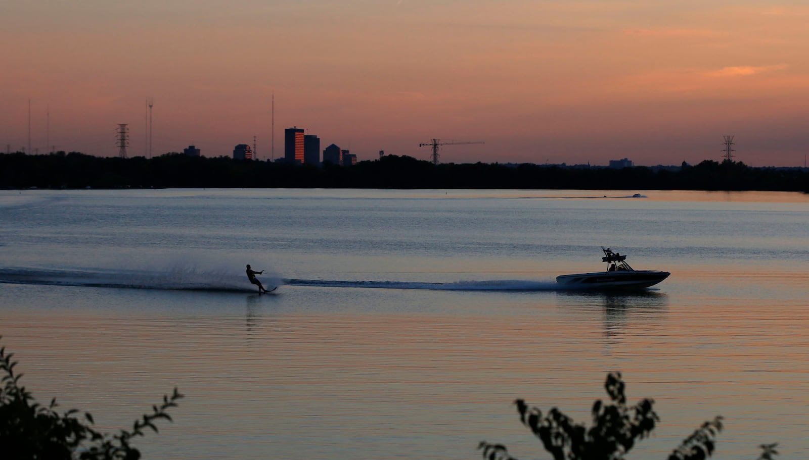 Kyle Savoie glide across across Eastwood Lake as it reflects the sunset twilight.  Eastwood Lake is part of the Great Miami Valley Buried Aquifer system.  TY GREENLEES / STAFF