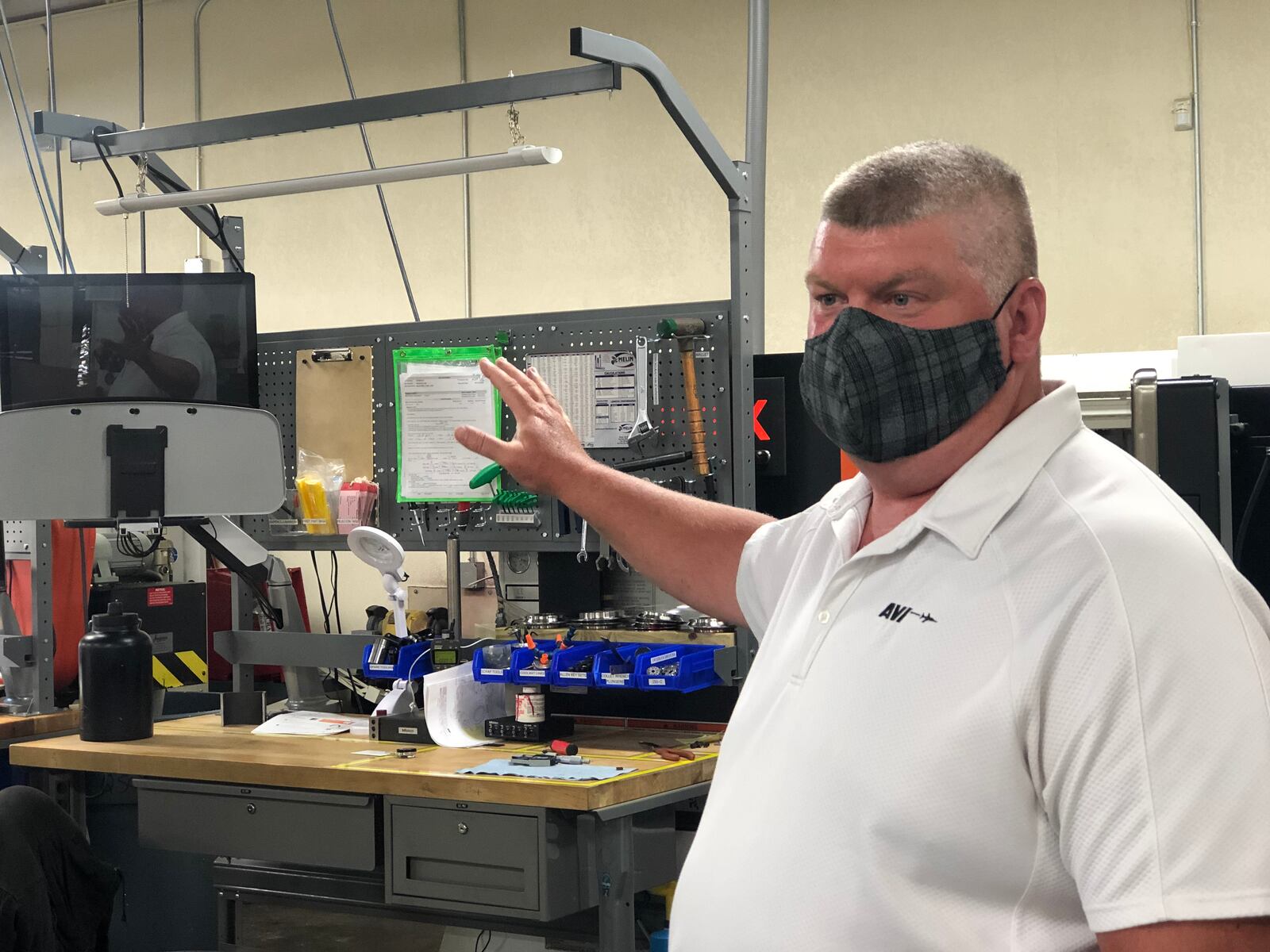 Tim Claude, director and general manager of Auto-Valve Inc., leads a tour through the Dayton facility. CORNELIUS FROLIK / STAFF