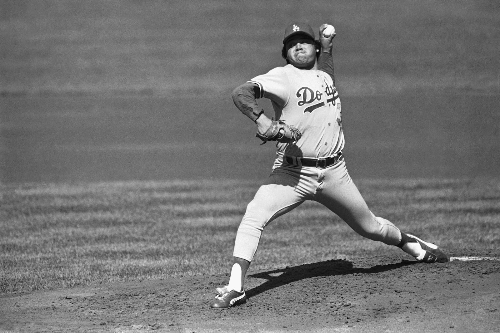 FILE - Los Angeles Dodgers pitcher Fernando Valenzuela pitches against a San Francisco Giants batter during the first inning at Candlestick Park, Oct. 3, 1982, in San Francisco. Fernando Valenzuela, the Mexican-born phenom for the Los Angeles Dodgers who inspired “Fernandomania” while winning the NL Cy Young Award and Rookie of the Year in 1981, has died Tuesday, Oct. 22, 2024. (AP Photo, File)