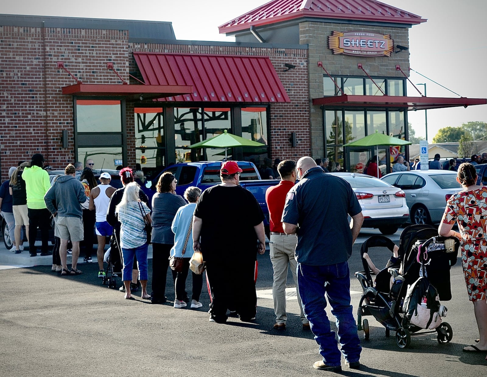 Nearly 100 people wait in line at the grand opening of the first Sheetz in Huber Heights on Tuesday, Aug. 29, 2023. MARSHALL GORBY \STAFF