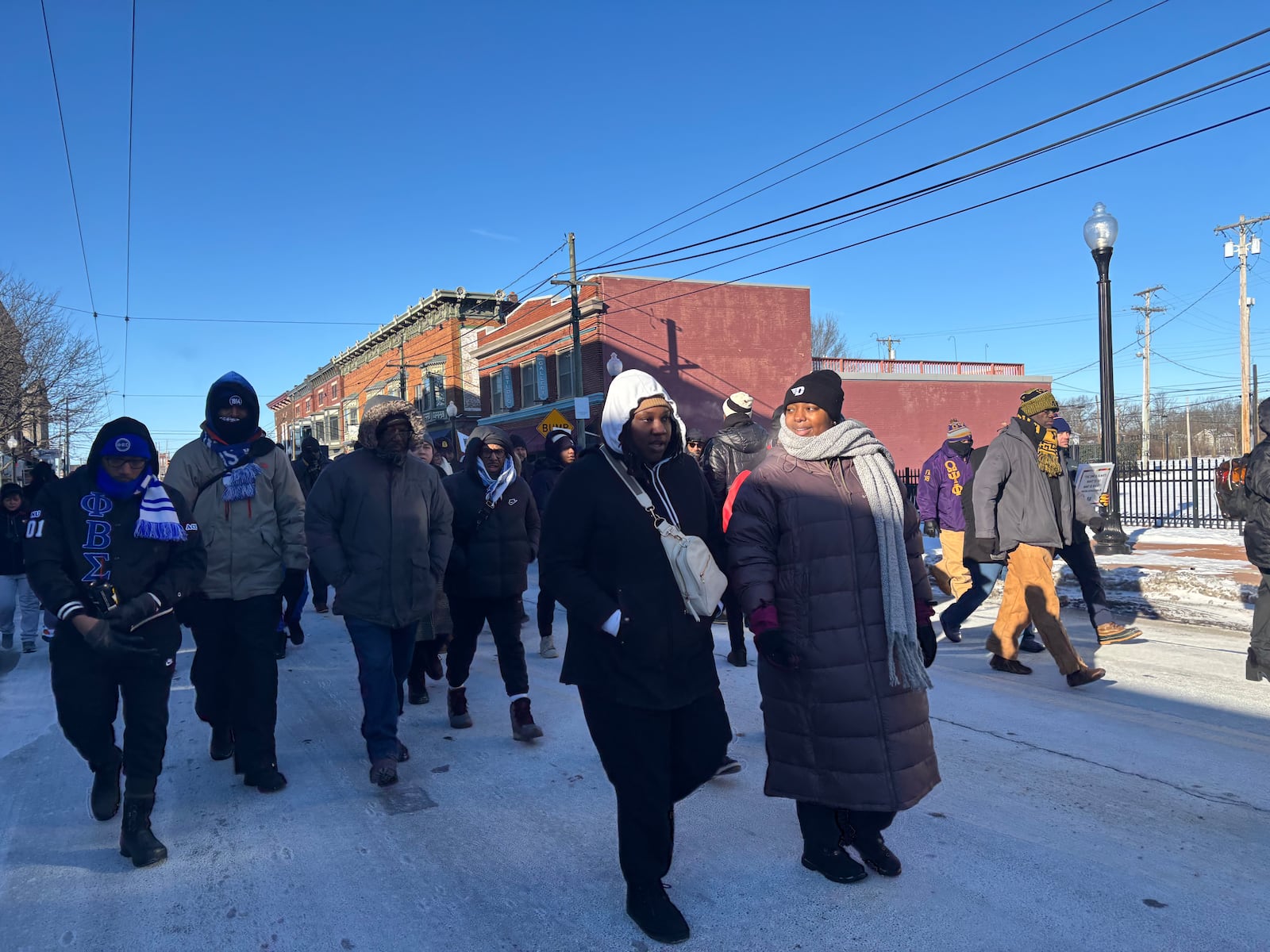 Marchers walk down East Third Street on Monday, Jan. 20 in honor of Martin Luther King, Jr. Eileen McClory / staff