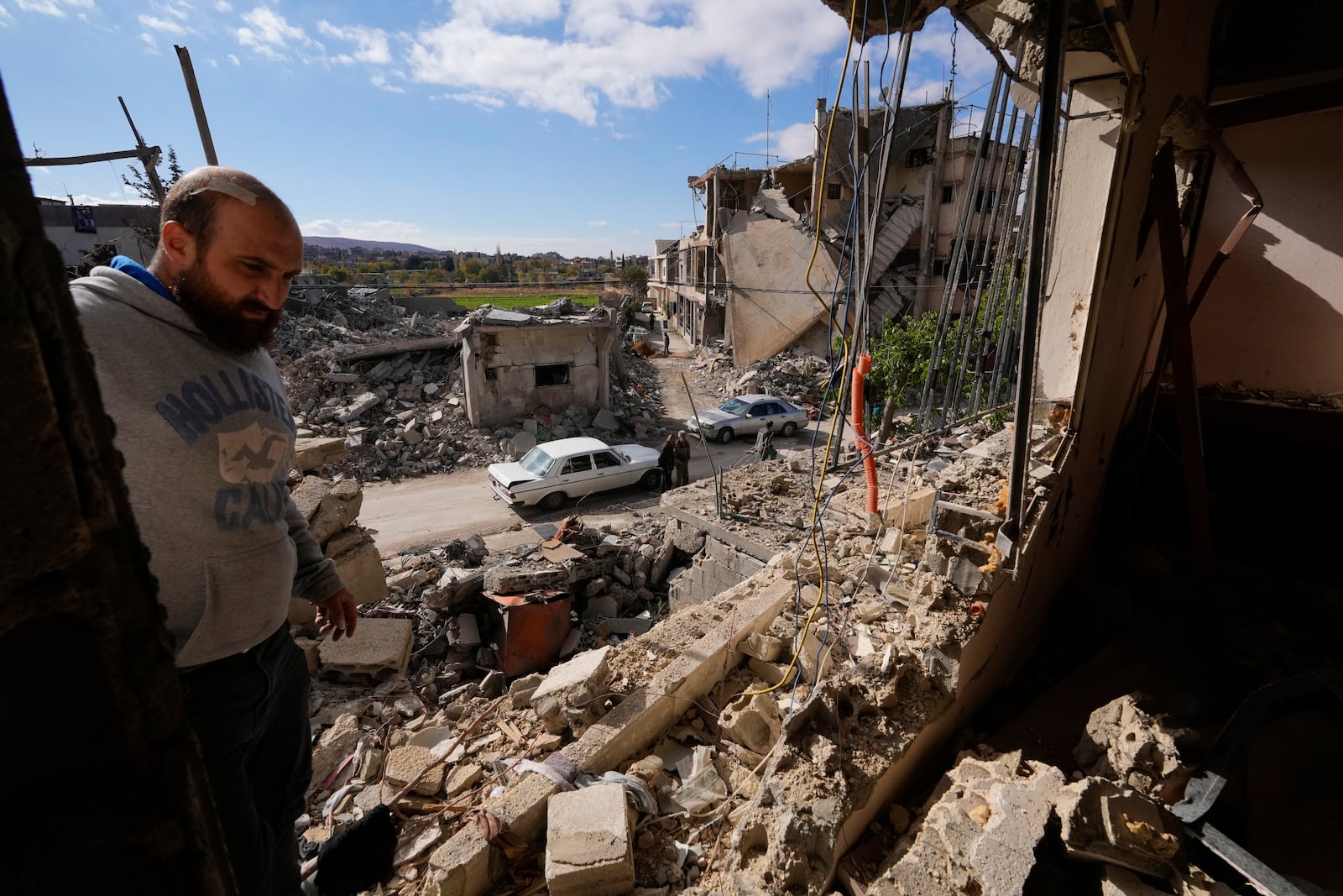 A resident checks a destroyed apartment in Baalbek, eastern Lebanon, Thursday, Nov. 28, 2024. (AP Photo/Hassan Ammar)