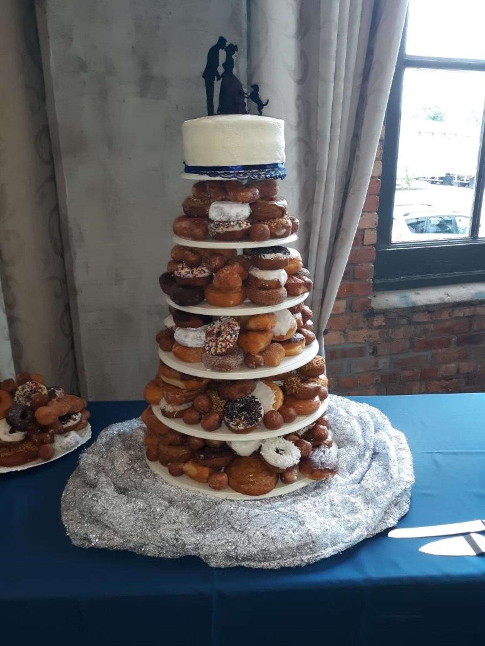 Anthony Lehmenkuler and Tori Blevins celebrated their wedding with this doughnut cake consisting primarily of 25 dozen assorted doughnuts from Bill's Donut Shop in Centerville.