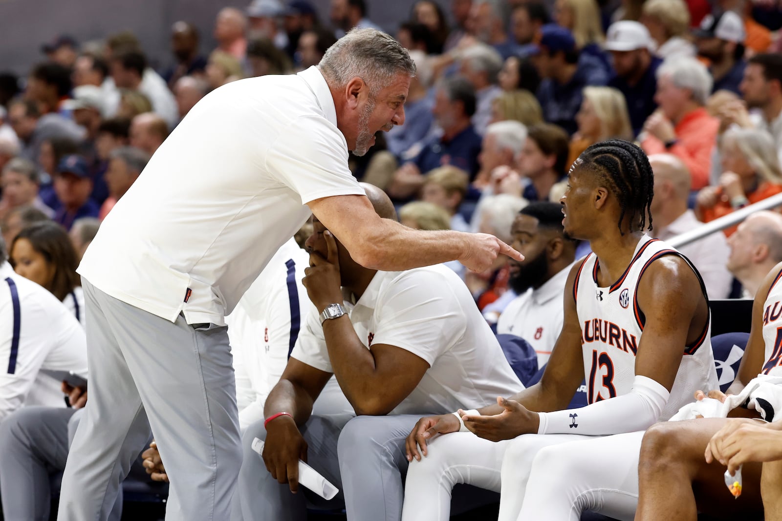 Auburn head coach Bruce Pearl talks with guard Miles Kelly (13) during the first half of an NCAA college basketball game against Alabama, Saturday, March 8, 2025, in Auburn, Ala. (AP Photo/Butch Dill)