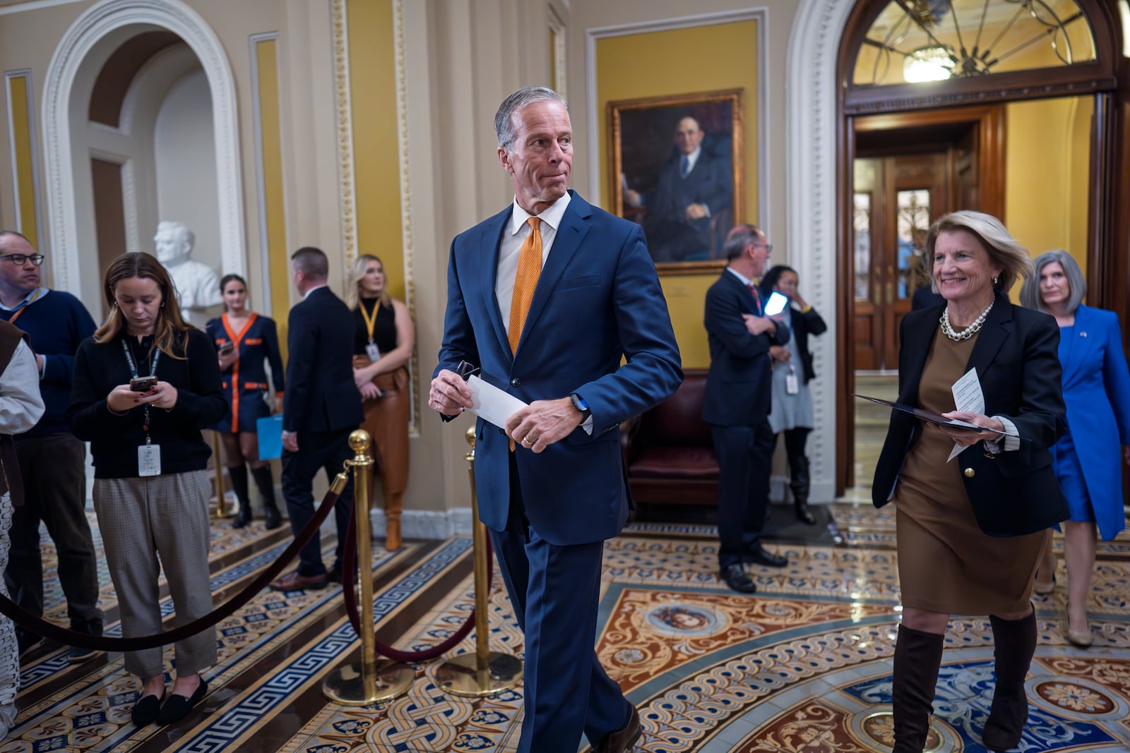 Senate Minority Whip John Thune, R-S.D., followed at right by Sen. Shelley Moore Capito, R-W.Va., arrives to speak to reporters following a Republican policy lunch at the Capitol in Washington, Tuesday, Dec. 10, 2024. (AP Photo/J. Scott Applewhite)