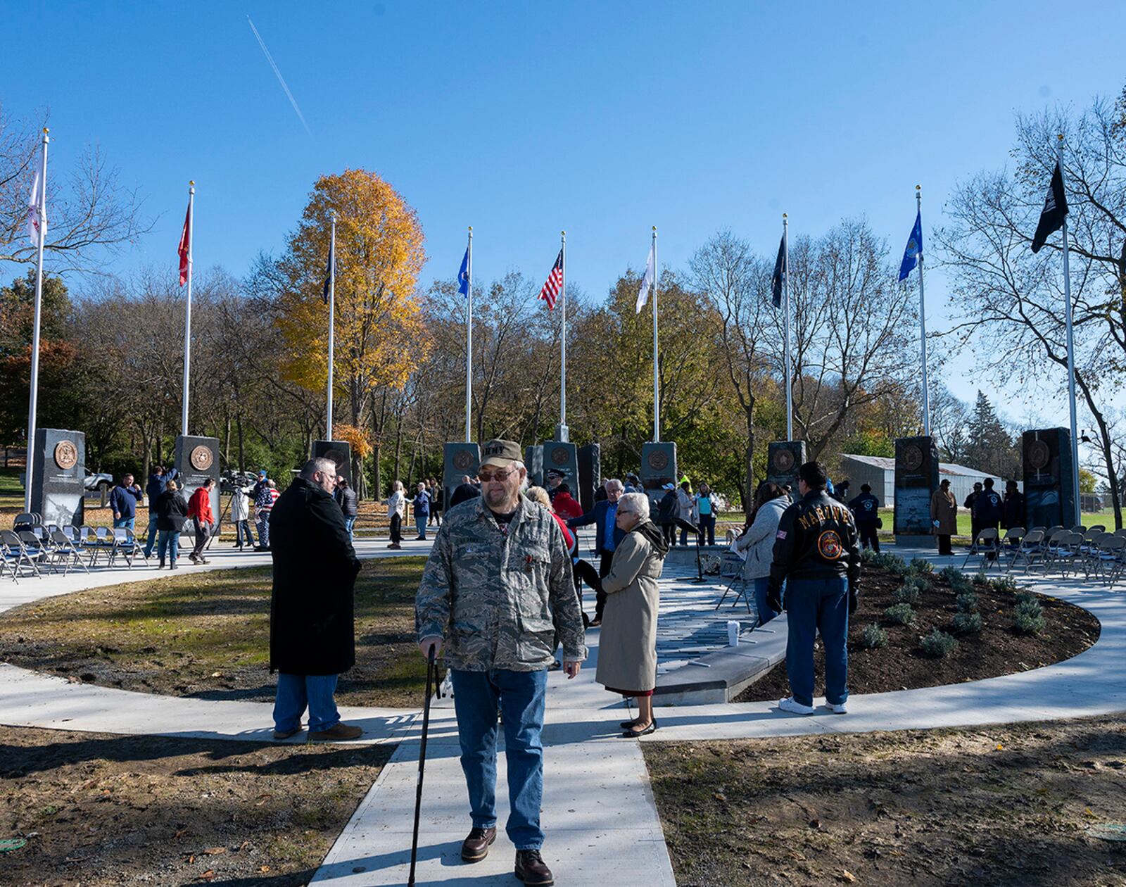 Attendees walk around the new Veterans Memorial Park following the dedication and ribbon cutting Nov. 6 at Thomas A. Cloud Park in Huber Heights. The memorial features plaques and flags commemorating all U.S. military branches, as well as POWs and MIAs. U.S. AIR FORCE PHOTO/R.J. ORIEZ