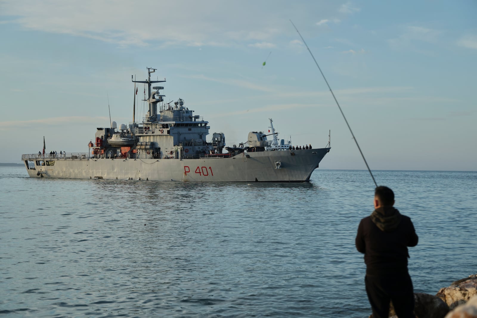 An Italian navy ship approaches the port, as Italy sends 49 more migrants to Albania for processing following earlier court rejections, in Shengjin, northwestern Albania, Tuesday, Jan. 28, 2025. (AP Photo/Vlasov Sulaj)