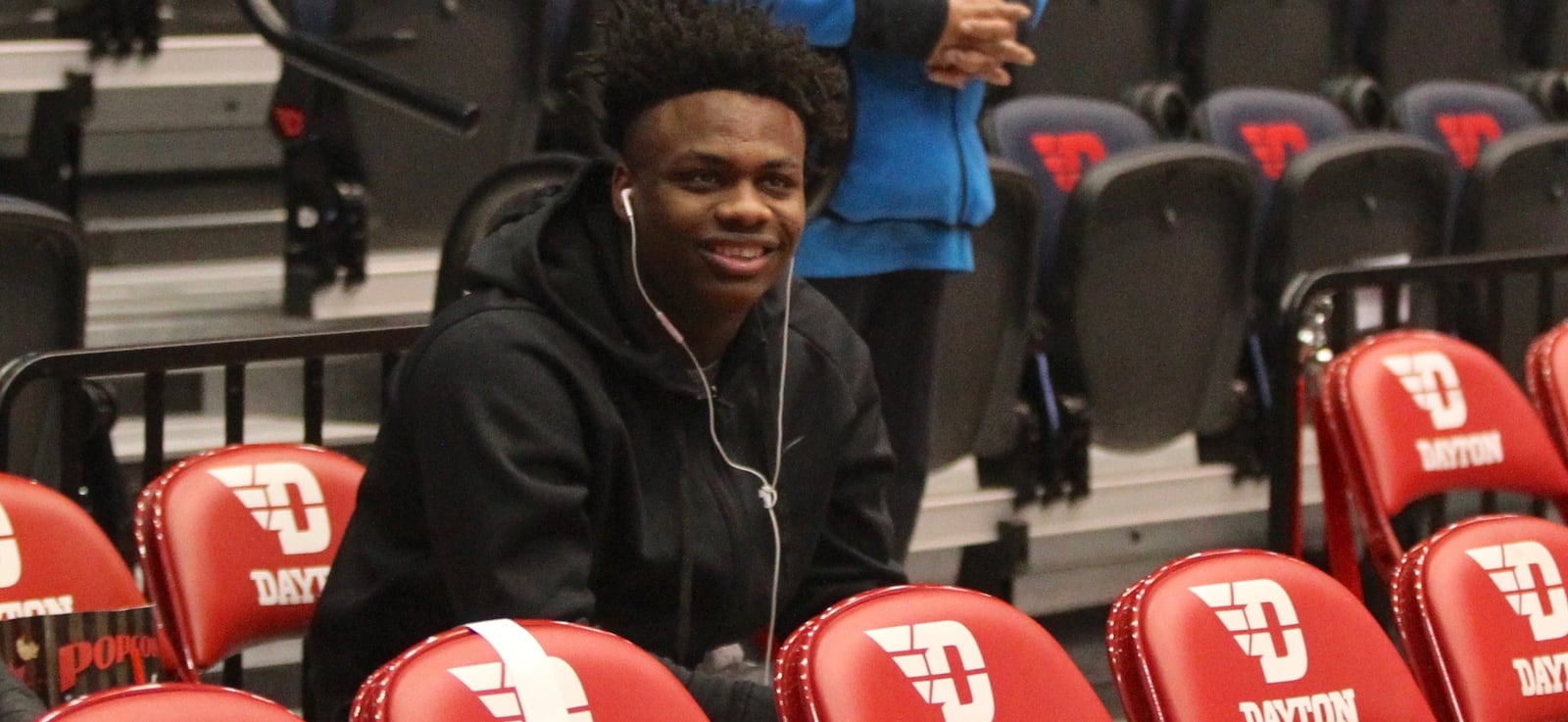 Posh Alexander sits behind the Dayton bench on Saturday, Feb. 2, 2019, at UD Arena.