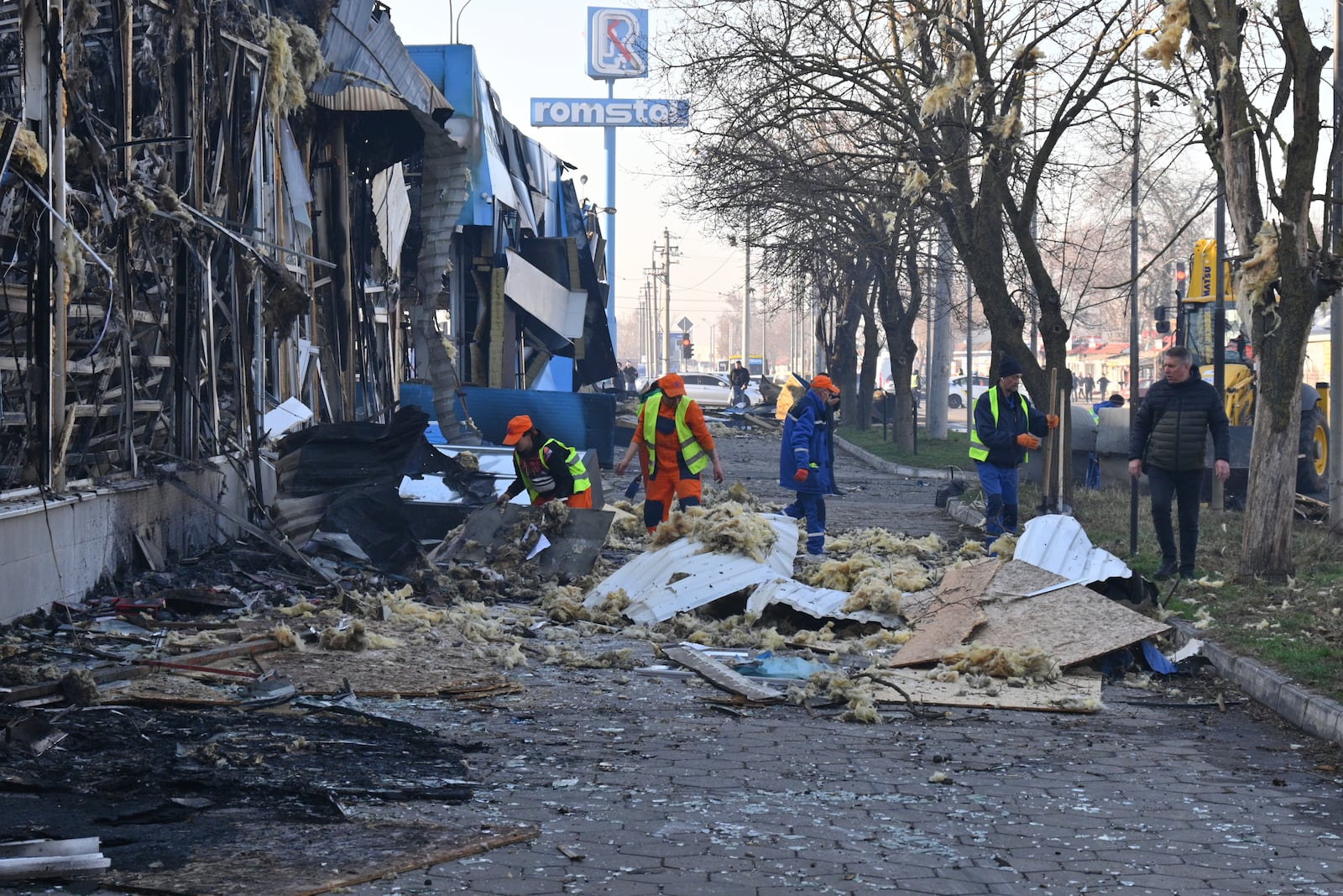 Municipal workers clean up after Russian drones hit shops during the night attack in Odesa, Ukraine, Friday, March 21, 2025. (AP Photo/Michael Shtekel)